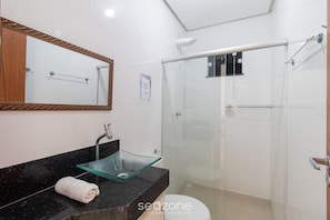 A modern bathroom with a glass sink, a large mirror, and a walk-in shower. - Apts in Condominium w/ Pool and Barbecue - Ctys (Porto Seguro)