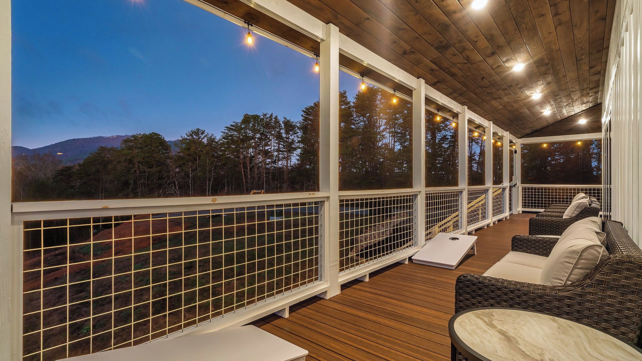 A covered outdoor seating area with a view of the mountains.