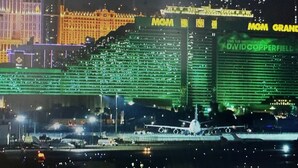 A nighttime view of a large building with illuminated signage, including "MGM GRAND" and "David Copperfield."