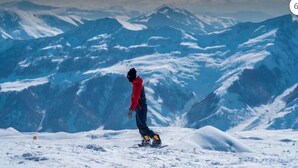 A snowboarder on a snowy mountain with a clear view of the surrounding peaks. - Altimera Collection - Stem - Ski-In/Ski-Out (Dusheti Municipality)