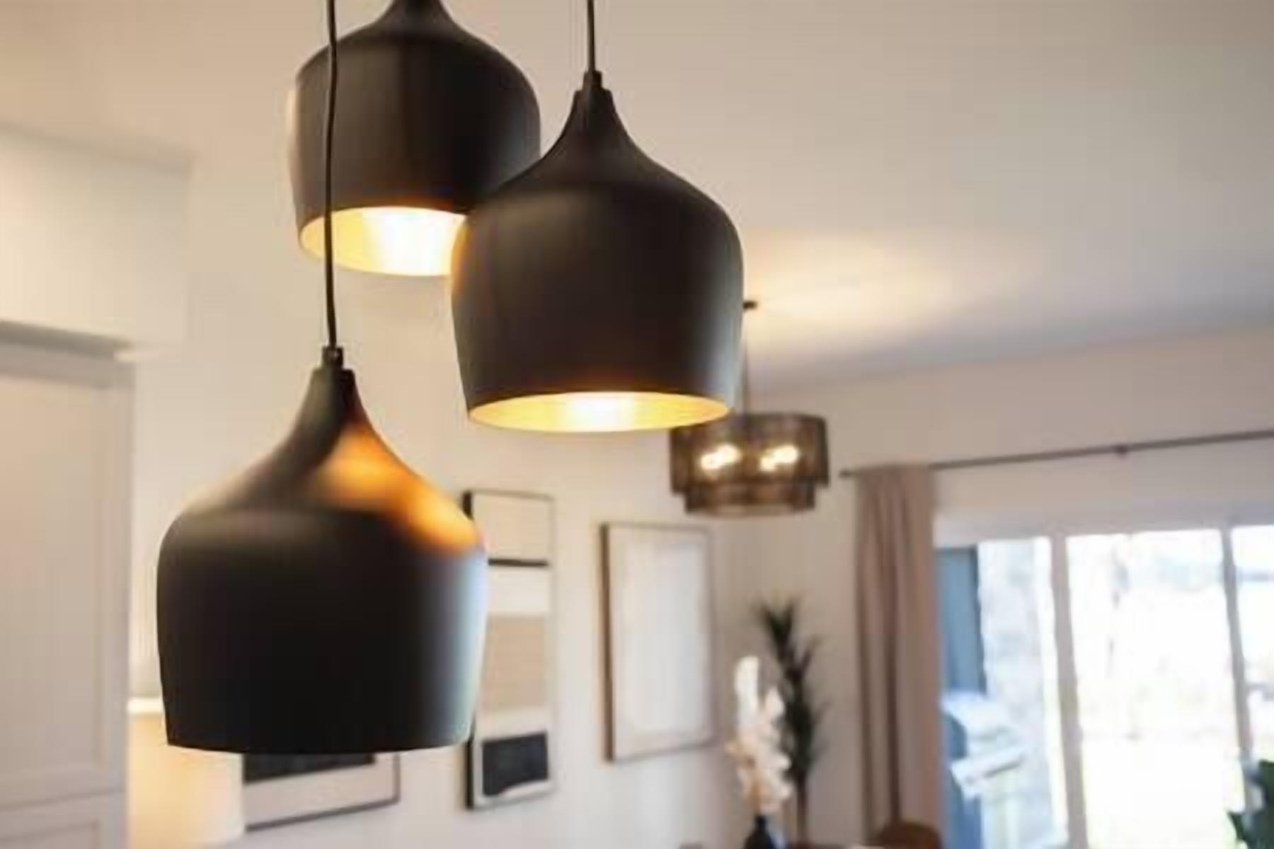A modern interior with pendant lighting and framed artwork on the wall.