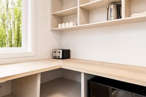 A kitchen with a built-in toaster, a kettle, and a dishwasher. - Spa - River - Game Room | Le Boréal (Mont-Tremblant)