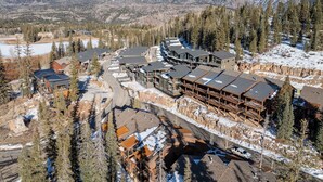 A resort with multiple buildings, a ski slope, and snow-covered mountains in the background. - Black Bear 50 - Ski-In/Out Durango Townhome (Durango)