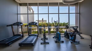 A gym with treadmills, stationary bikes, and elliptical machines. - Spectacular 1 Bedroom Apt - 14th Floor Morros City (Cartagena)