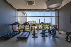 A gym with treadmills, elliptical machines, and stationary bikes. - Spectacular 2 Bedroom Apt -14th Floor Morros City (Cartagena)