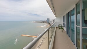 A balcony with a view of the sea and a distant cityscape. - Luxurious 3 Bedroom apt - 3303 Palmetto Beach (Cartagena)