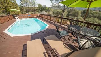 Seasonal outdoor pool, open 9:00 AM to 10:00 PM, pool umbrellas