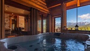 A hot tub in a log cabin with a mountain view. - Miracle Lodge - Hot Tub, Golf & Mountain Views (Leavenworth)