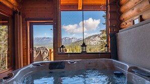 A hot tub with a view of mountains through a window. - Miracle Lodge - Hot Tub, Golf & Mountain Views (Leavenworth)