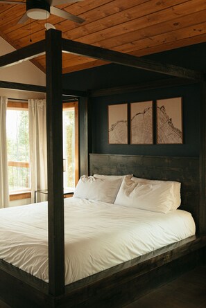 A bedroom with a four-poster bed, wooden ceiling beams, and three framed artworks on the wall. - Family-Friendly Luxury Cabin SLIDE+SWINGSET+Movie Room - Hot Tub & Mountain View (Piercetown)