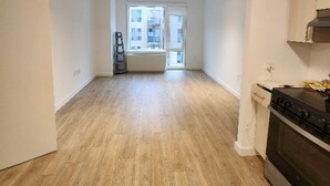 A spacious kitchen with wooden flooring, a built-in oven, and a window overlooking a residential area. - Long term,1 bdr/apt in BRKL Barklay Ctr,move-out Oct1st, availableNOW,3,450month (Brooklyn)