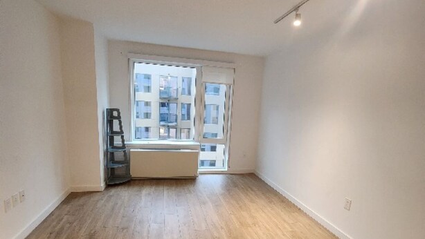 A spacious room with wooden flooring, a large window, and a radiator. - Long term,1 bdr/apt in BRKL Barklay Ctr,move-out Oct1st, availableNOW,3,450month (Brooklyn)