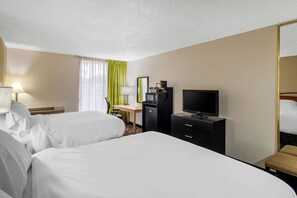 A hotel room with two beds, a desk with a computer, a television, and a mirror. - Stay Express Inn & Suites Tyler (Tyler)