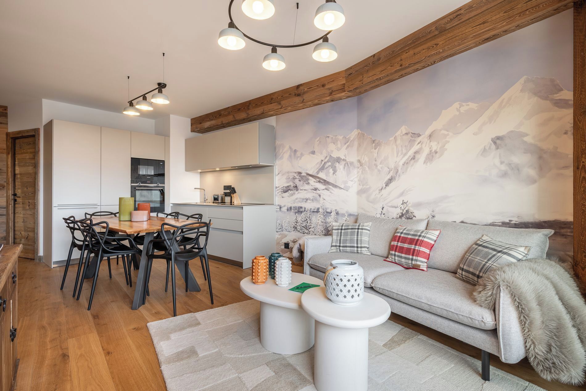 A modern living room with a sofa, coffee table, and dining area.