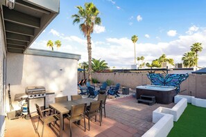 An outdoor patio with a grill, seating, and a hot tub. - Refreshing Pool • Hot Tub • Game Room • Sleeps 11 (Scottsdale)