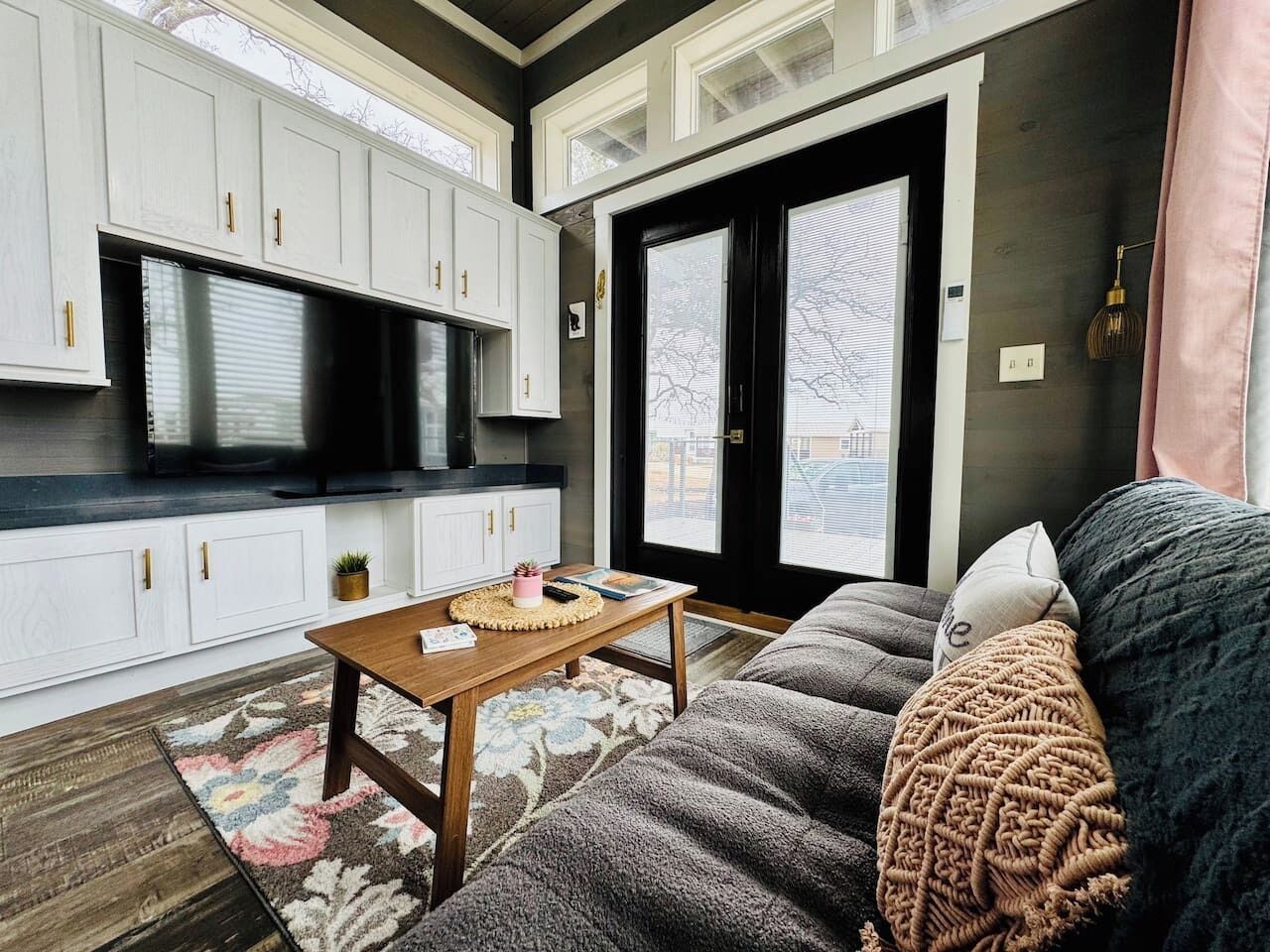 A modern living room with a sofa, a coffee table, and a TV.