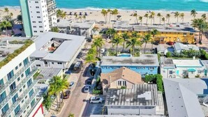 A coastal urban area with buildings, a beach, and palm trees. - Cozy 2BR aparthotel near hollywood boardwalk (Hollywood)