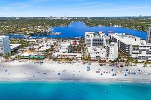 A coastal cityscape with a beachfront, buildings, and a marina. - Bright 1BR aparthotel near beach w/ free parking (Hollywood)