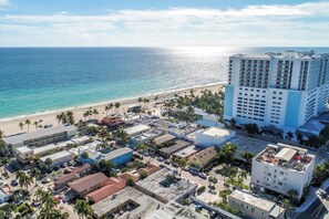 A coastal hotel with a beach view, multiple buildings, and a parking area. - Modern apt w/queen bed & beach steps (Hollywood)