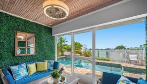 A room with a pool, a sofa, and a view of the outdoors. - Waterfront - Private Pool - Game Room (Largo)