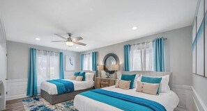 A bedroom with two beds, a ceiling fan, and a nightstand with a lamp. - Waterfront - Private Pool - Game Room (Largo)