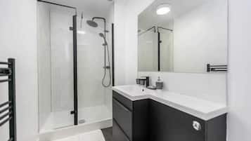 Shower, hair dryer, towels, shampoo