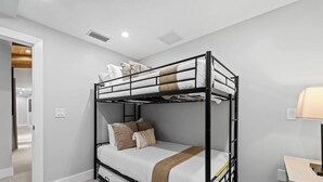 A bunk bed room with a desk and lamp. - Villa w/Pool, Firepit & BBQ (Dania Beach)