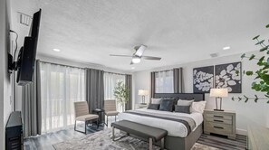 A modern hotel room with a bed, bedside tables, a desk, a chair, a bench, a ceiling fan, and a TV. - Pool - Basketball -Soccer - Game Room - Playground (Largo)