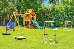 A playground with a slide, swings, and climbing structures. - Pool - Pickleball - Soccer - Basket - Sleeps 18! (Tampa)