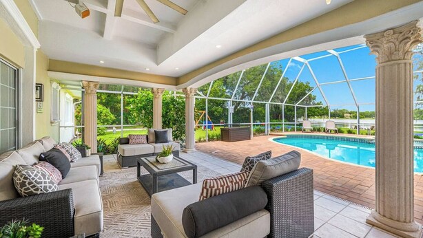 A covered outdoor area with a pool, seating, and a view of the outdoors. - Pool - Pickleball - Soccer - Basket - Sleeps 18! (Tampa)
