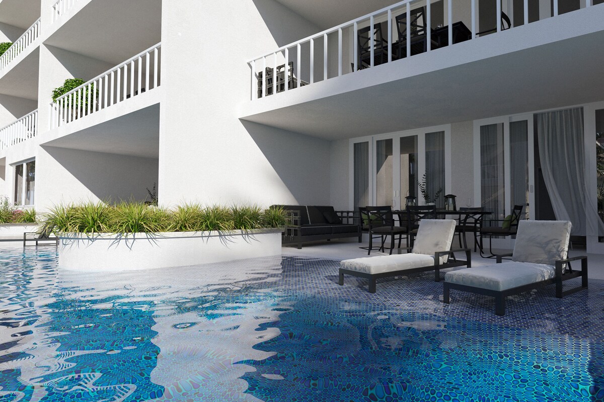 A modern hotel with a rooftop pool, outdoor seating, and a white facade.