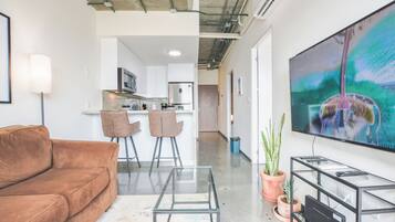 Suite junior, balcón, vista a la ciudad | Área de sala de estar