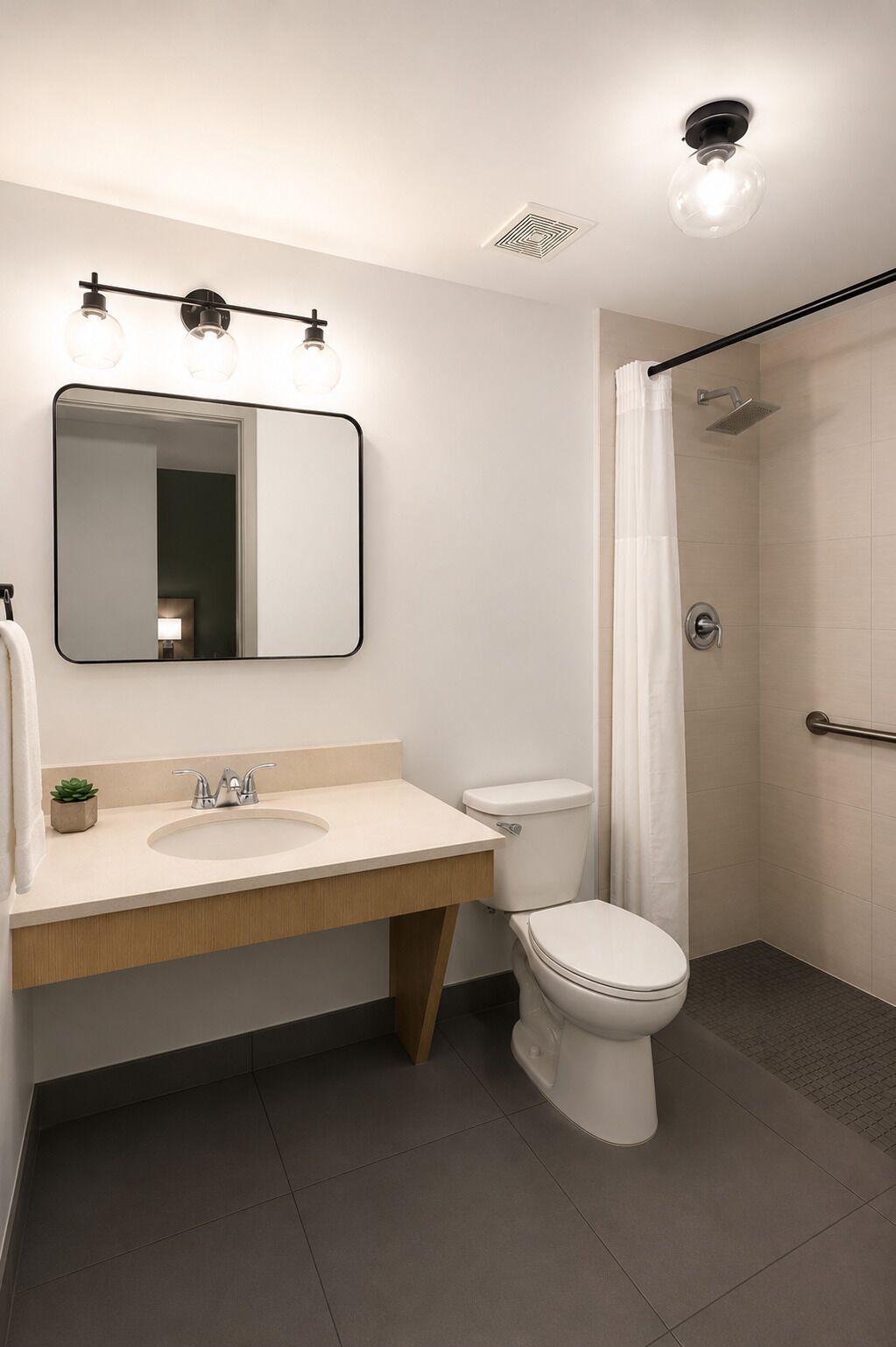 A modern bathroom with a sink, toilet, and shower.