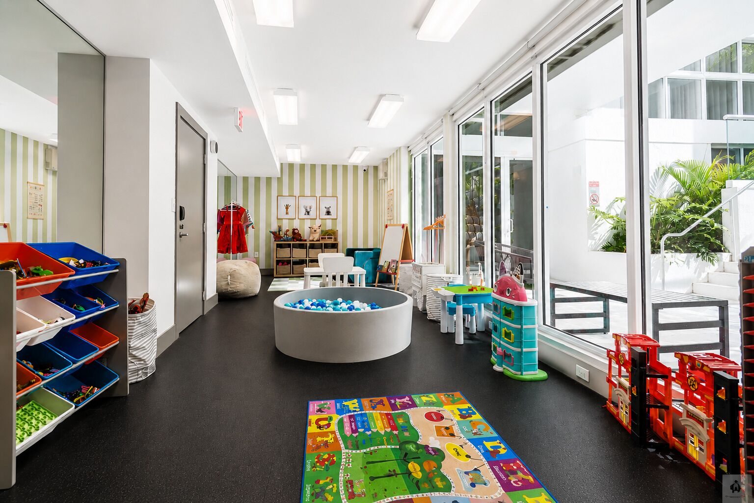 A children's play area with storage bins, a ball pit, and educational toys.