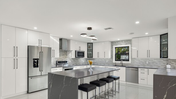 A modern kitchen with a large island, stainless steel appliances, and a sleek design. - 6 bedroom Oasis with Extra Large Pool, spa, EV Charger & Guest House, Sleeps 16+ (Naples)