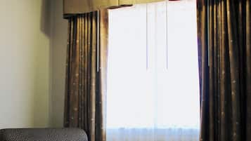 Desk, laptop workspace, blackout drapes, iron/ironing board