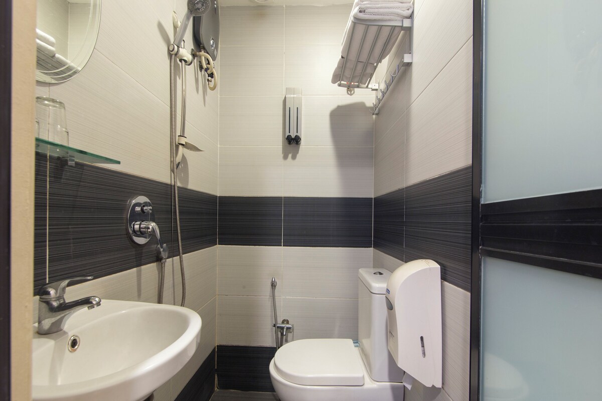 A modern bathroom with a sink, toilet, and shower.