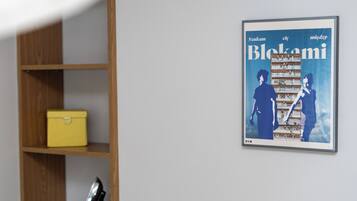 A framed poster with the text "Szukam Blekami" on a wall.