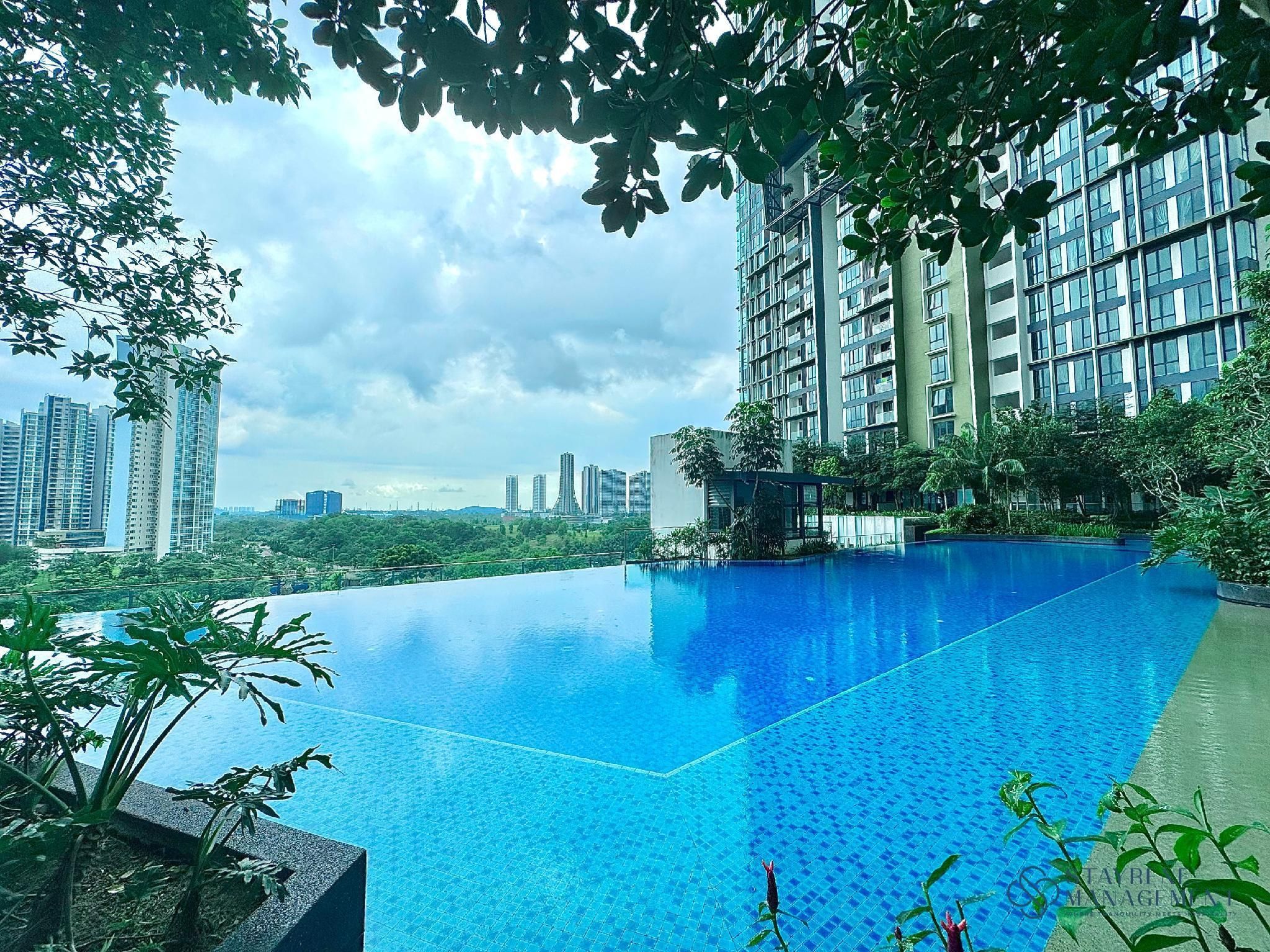 A rooftop infinity pool with a city skyline in the background.