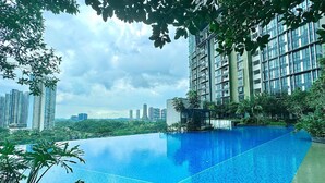 A rooftop infinity pool with a city skyline in the background. - The Elysia Suites (Iskandar Puteri)