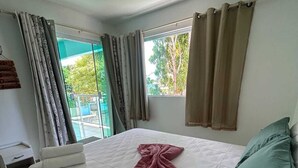 A bedroom with a bed, a window, and curtains. - 15 suites in the center of Porto de Galinhas. Oasis on the most beautiful beach in Pernambuco. (Ipojuca)