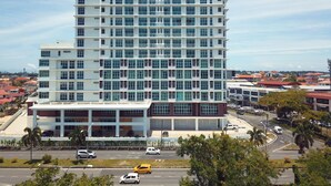 A multi-story hotel with a modern architectural design, featuring a prominent glass facade and a flat roof. - Stirling Suites Hotel & Serviced Apartment (Miri)