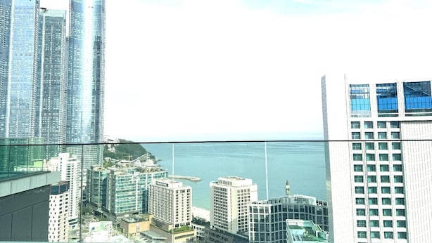 A person relaxing in a pool with a cityscape view.