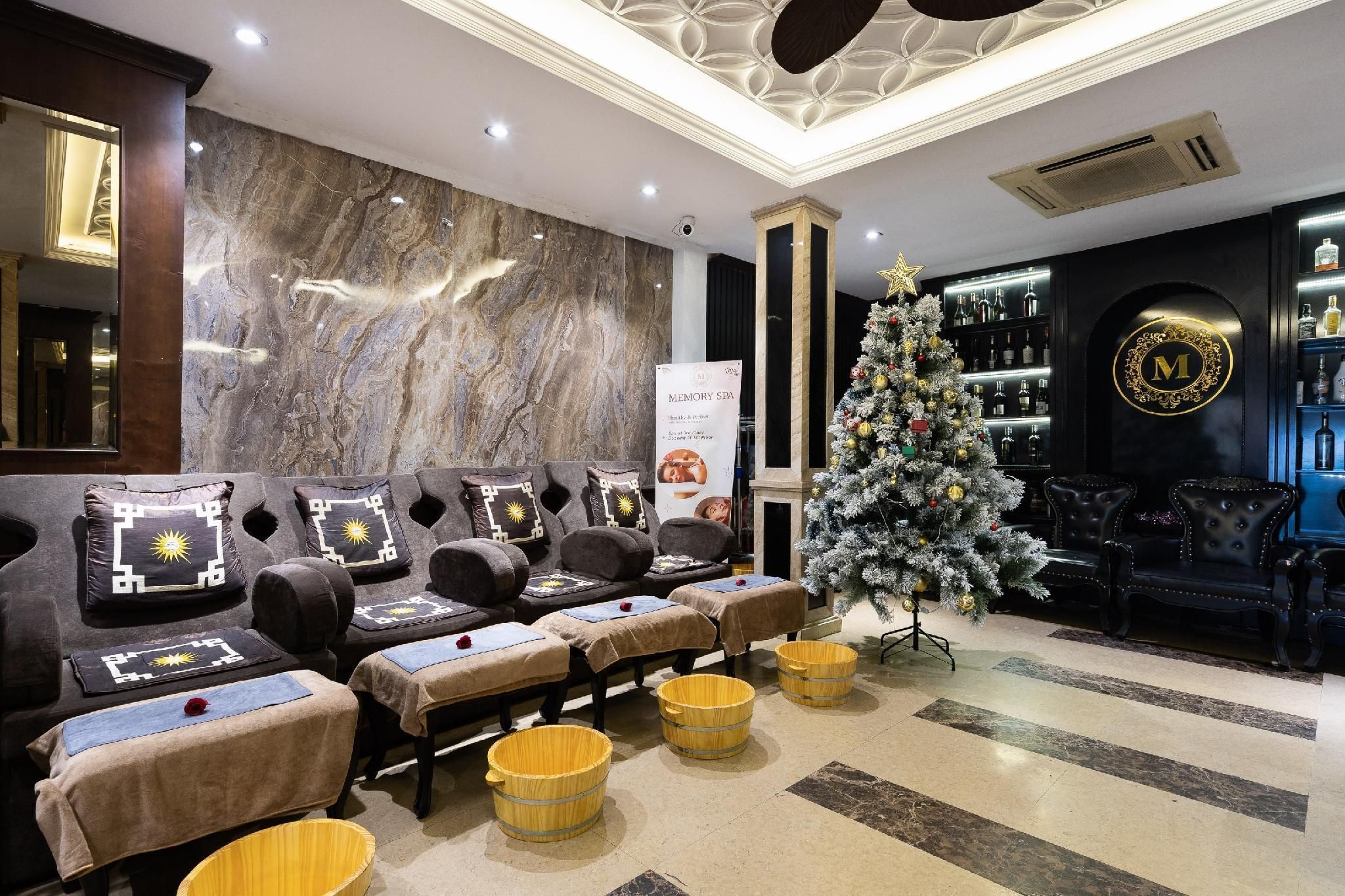 A spa area with massage chairs, a Christmas tree, and a bar with bottles.