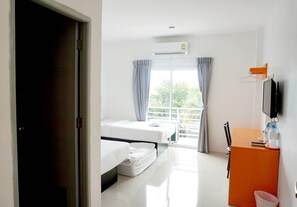 A hotel room with a bed, a desk, a television, and a window with curtains. - Wangmaewmeo (Rayong)
