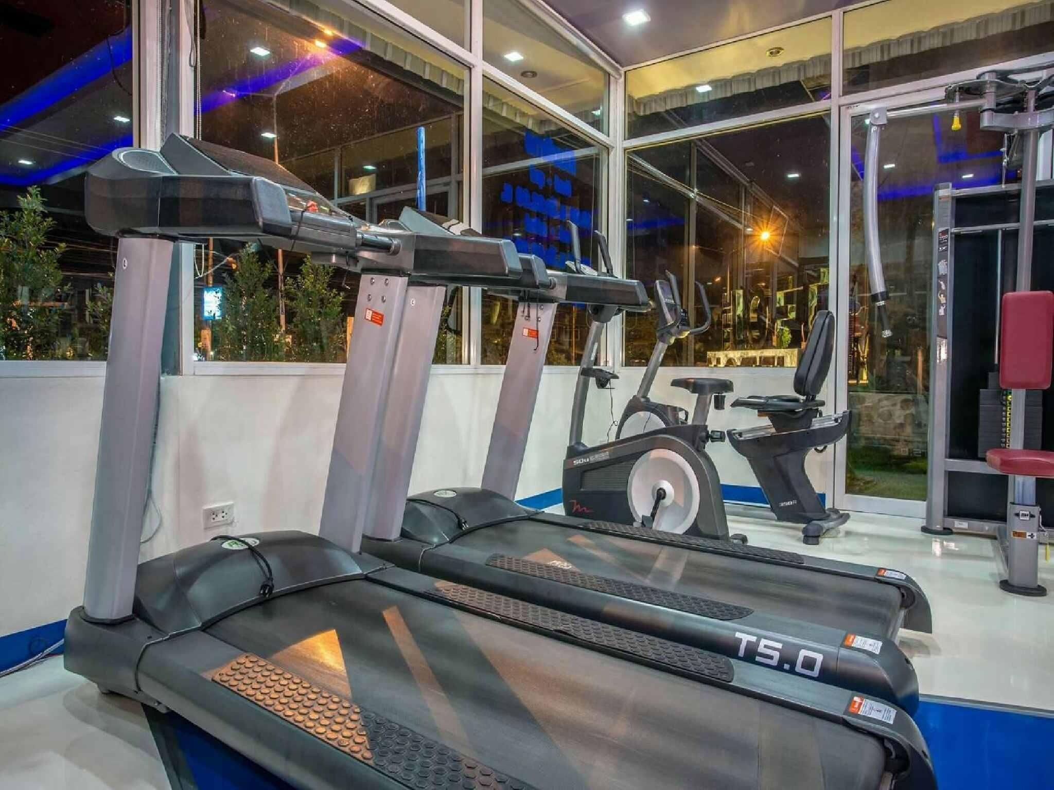 A gym with treadmills, an elliptical, and a weight machine.