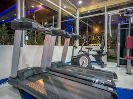 A gym with treadmills, an elliptical, and a weight machine.