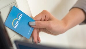 A hand inserting a blue card into a slot. - Hop Inn Ayutthaya (Ayutthaya)