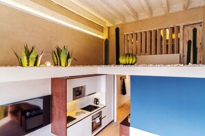 A modern kitchen with white cabinets, a built-in oven, and a microwave. - Enjoybcn Plaza Catalunya Apartment (Barcelona)