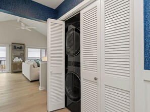 A laundry room with a door open, revealing two washing machines. - Luxury Lakefront Living | New vacation rental (Spring Lake)